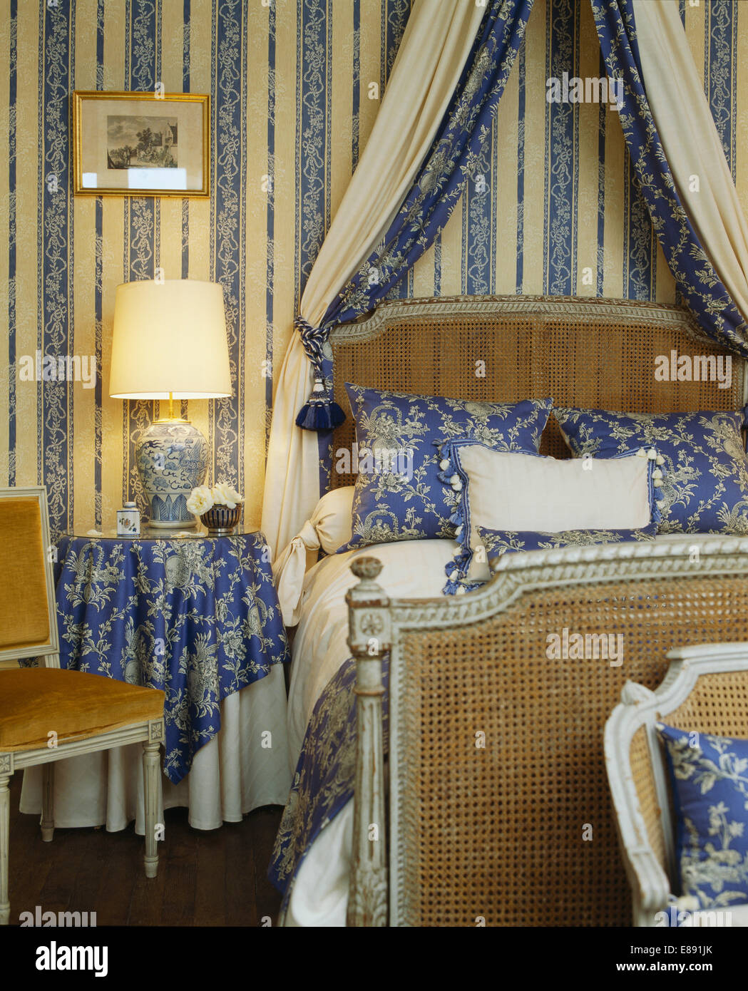 Blue Cream Striped Wallpaper And Lighted Lamp In Bedroom
