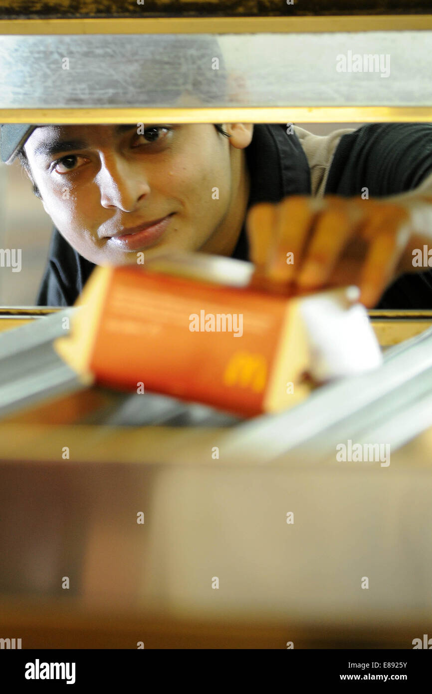 McDonald's worker employee working at a McDonald's fast food restaurant. Stock Photo