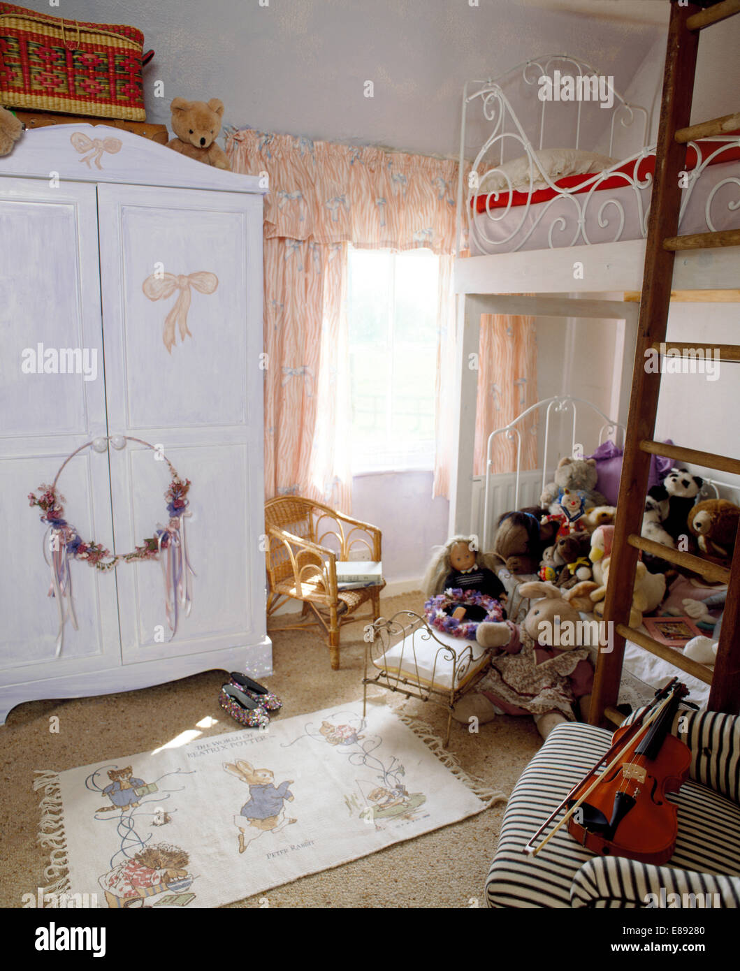 Painted Wardrobe With Painted Pink Bows In Child S Bedroom