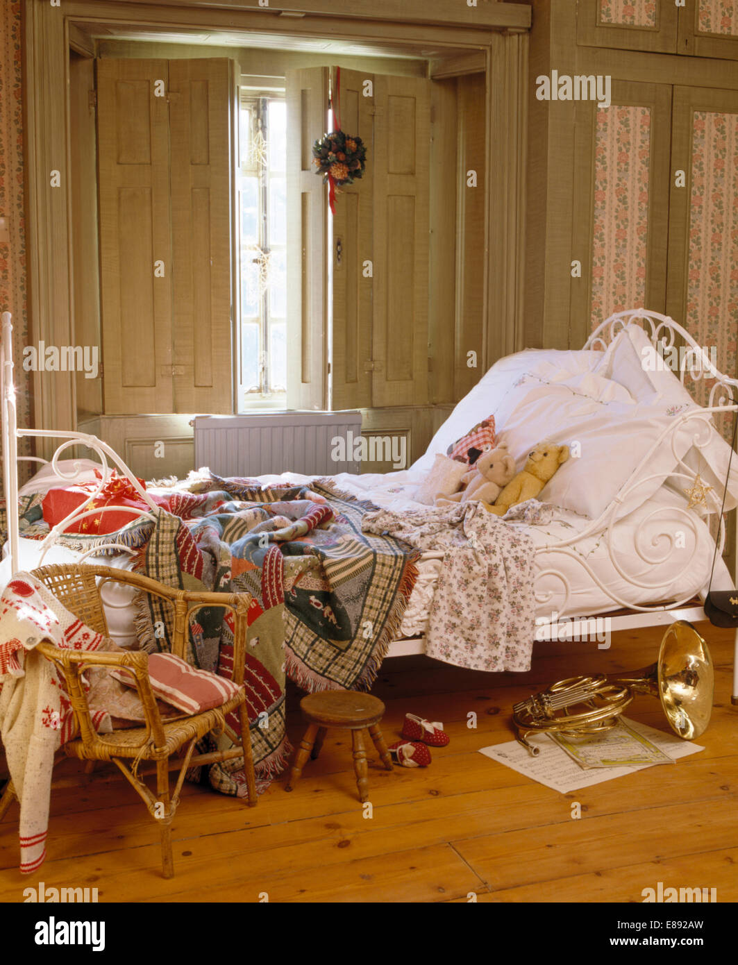 Throws And White Linen On White Cast Iron Bed In Front Of