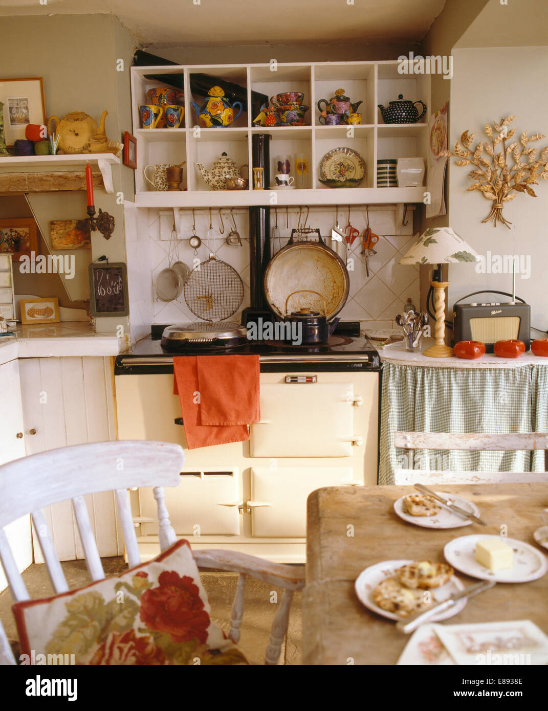 https://c8.alamy.com/comp/E8938E/cube-shelves-above-cream-aga-in-cottage-kitchen-with-white-painted-E8938E.jpg