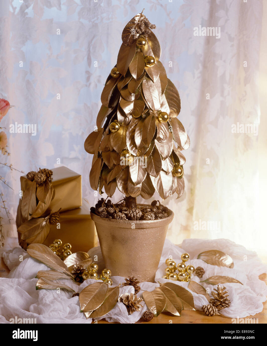 Closeup of miniature Christmas tree made from gold painted leaves in