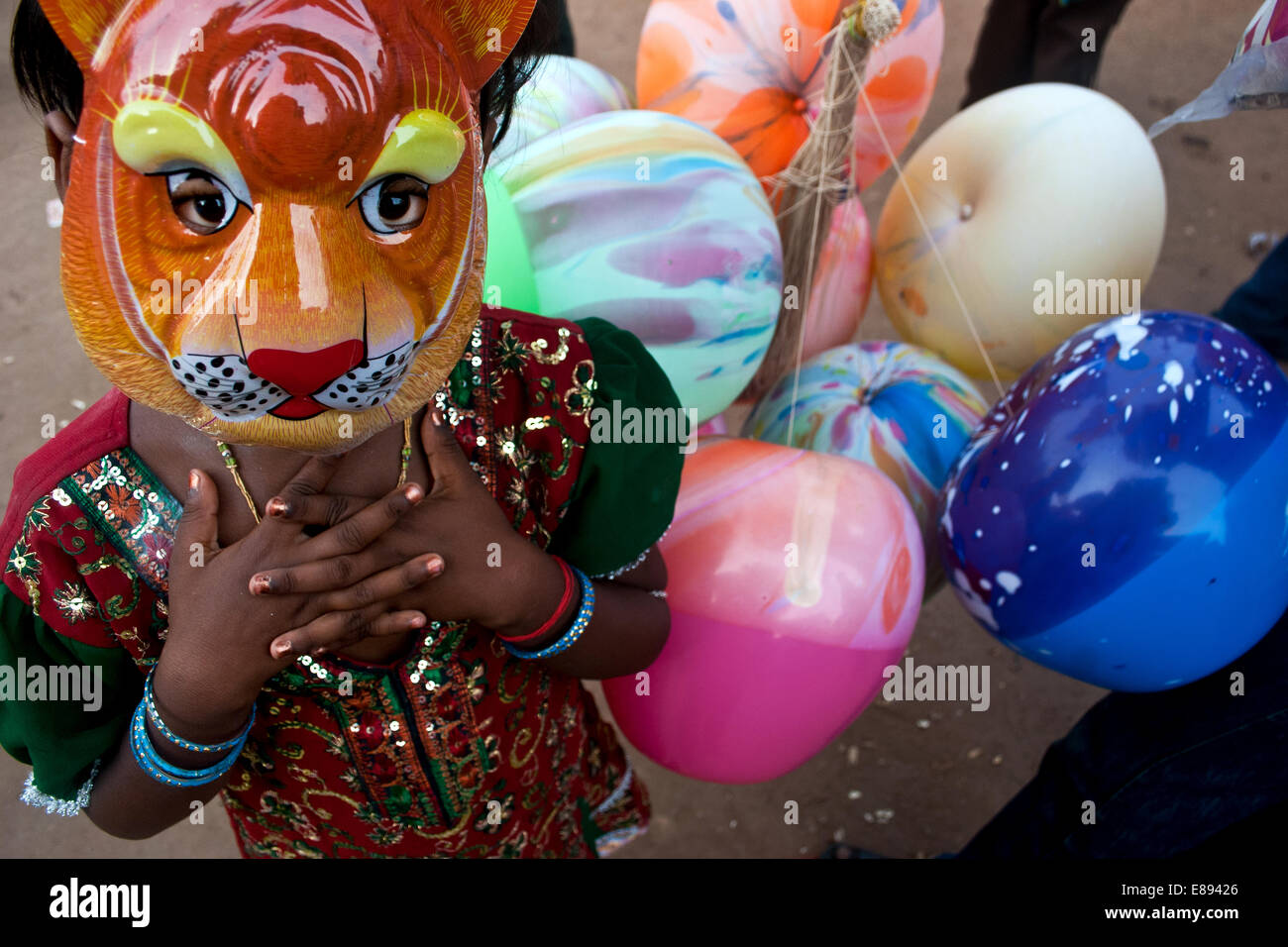 Girl wearing a lion mask, West Bengal, India Stock Photo Alamy
