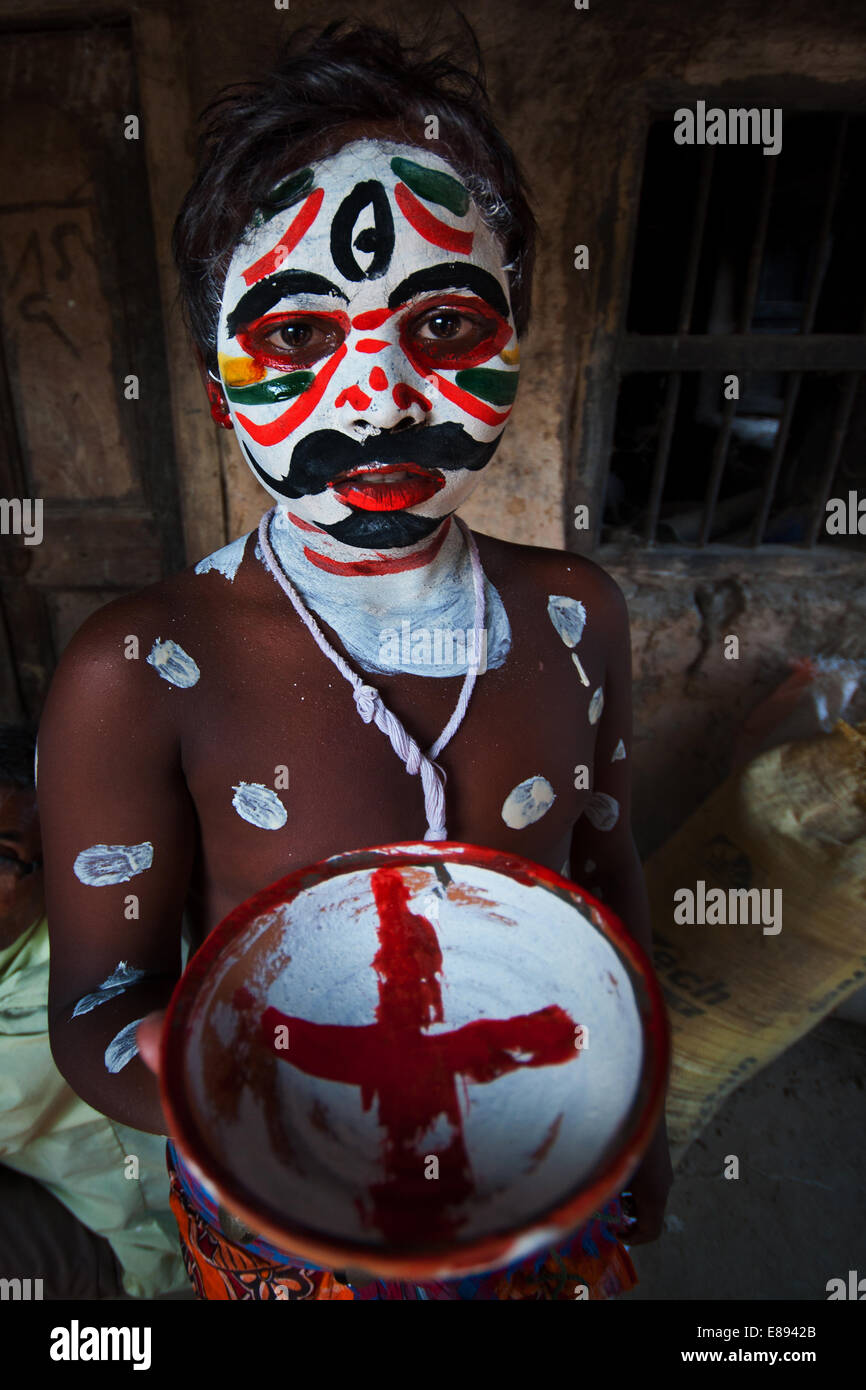 Teenage boy with painted faces celebrating Gajan festival, Kolkata, West Bengal, India. Stock Photo