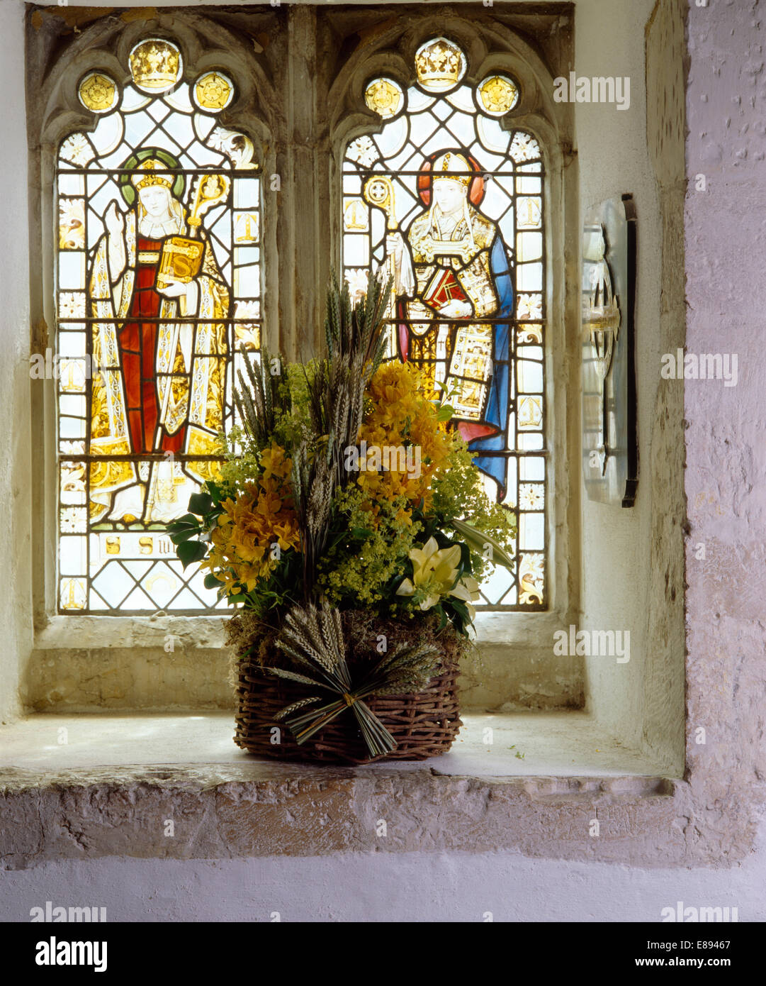 Still Life Of Summer Flowers On Windowsill Of Stained Glass Church