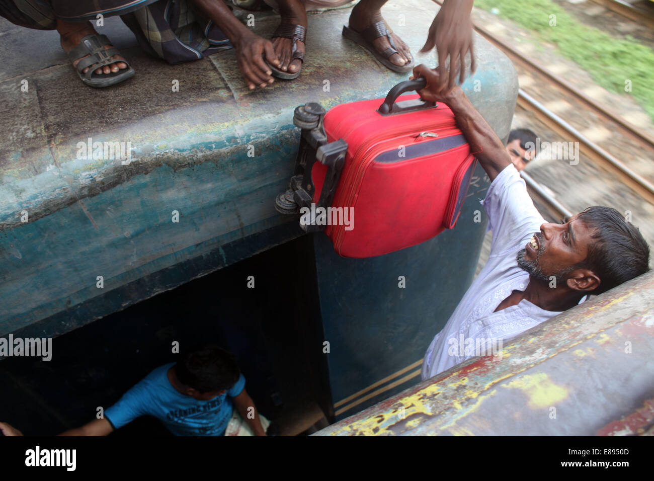 Dhaka, Bangladesh. 2nd Oct, 2014. Crowds of people board the roofs of trains in Dhaka, Bangladesh, for a risky ride to their home villages. Millions of city dwellers return home for Eid al-Adha. Credit:  Zakir Hossain Chowdhury/ZUMA Wire/Alamy Live News Stock Photo