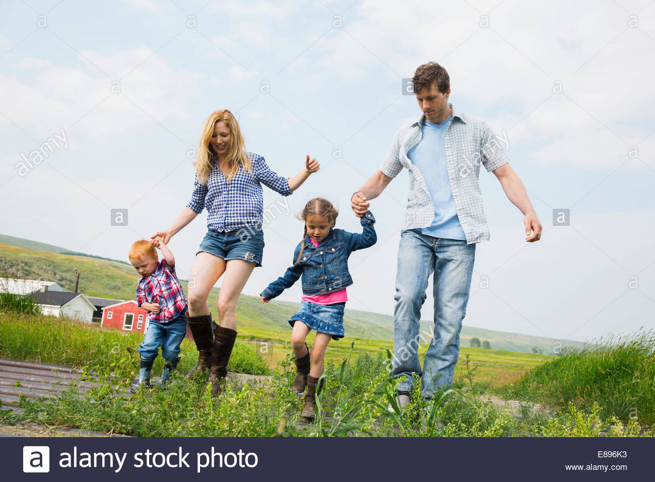 Family walking in rural field Stock Photo