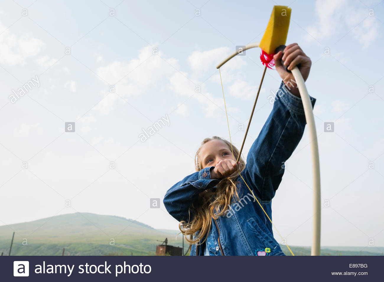 Girl playing with bow and arrow Stock Photo Alamy