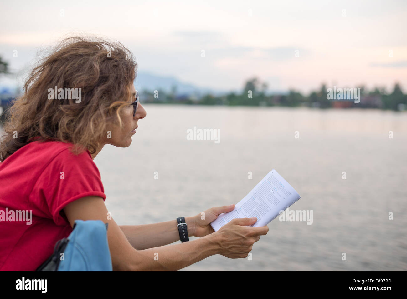 Woman Reading A Guide Open page travel guide hi-res stock photography and images - Alamy