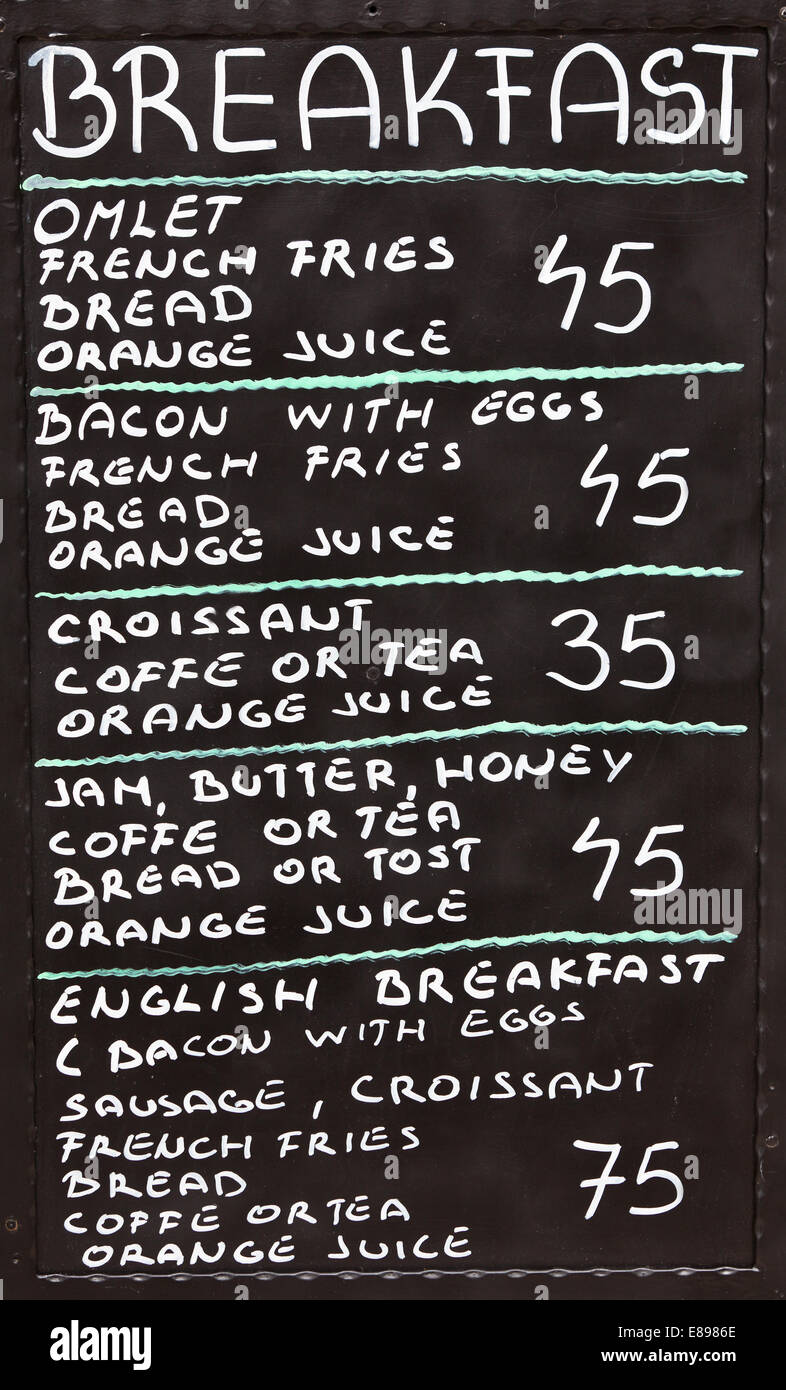 Street cafe breakfast menu written in chalk on a blackboard. Vertical shot Stock Photo