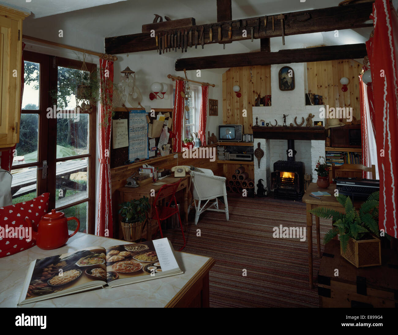 Cottage Living And Dining Room With Black Cast Iron Stove In Stock