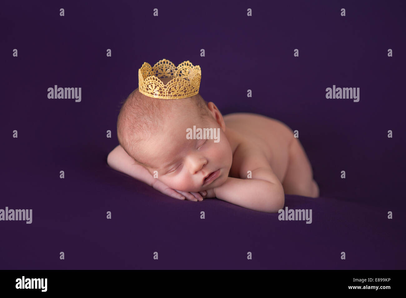 Portrait of newborn baby girl wearing a gold crown Stock Photo Alamy