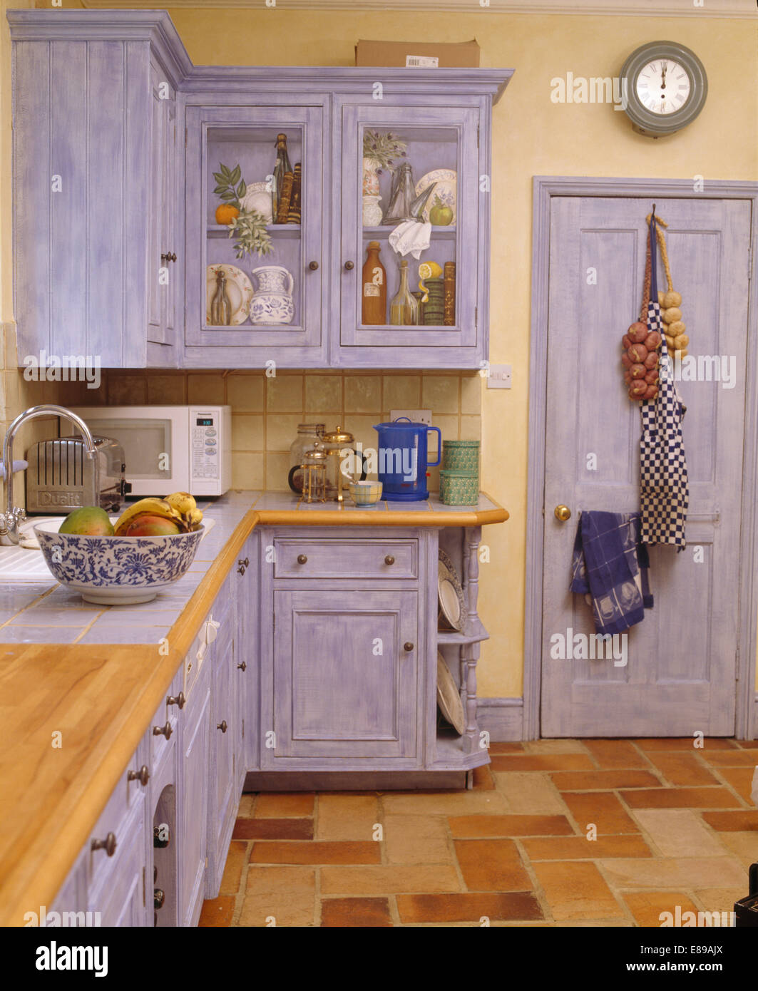 Trompe-l'oeil on cupboard in kitchen with dragging effect fitted blue cupboards Stock Photo