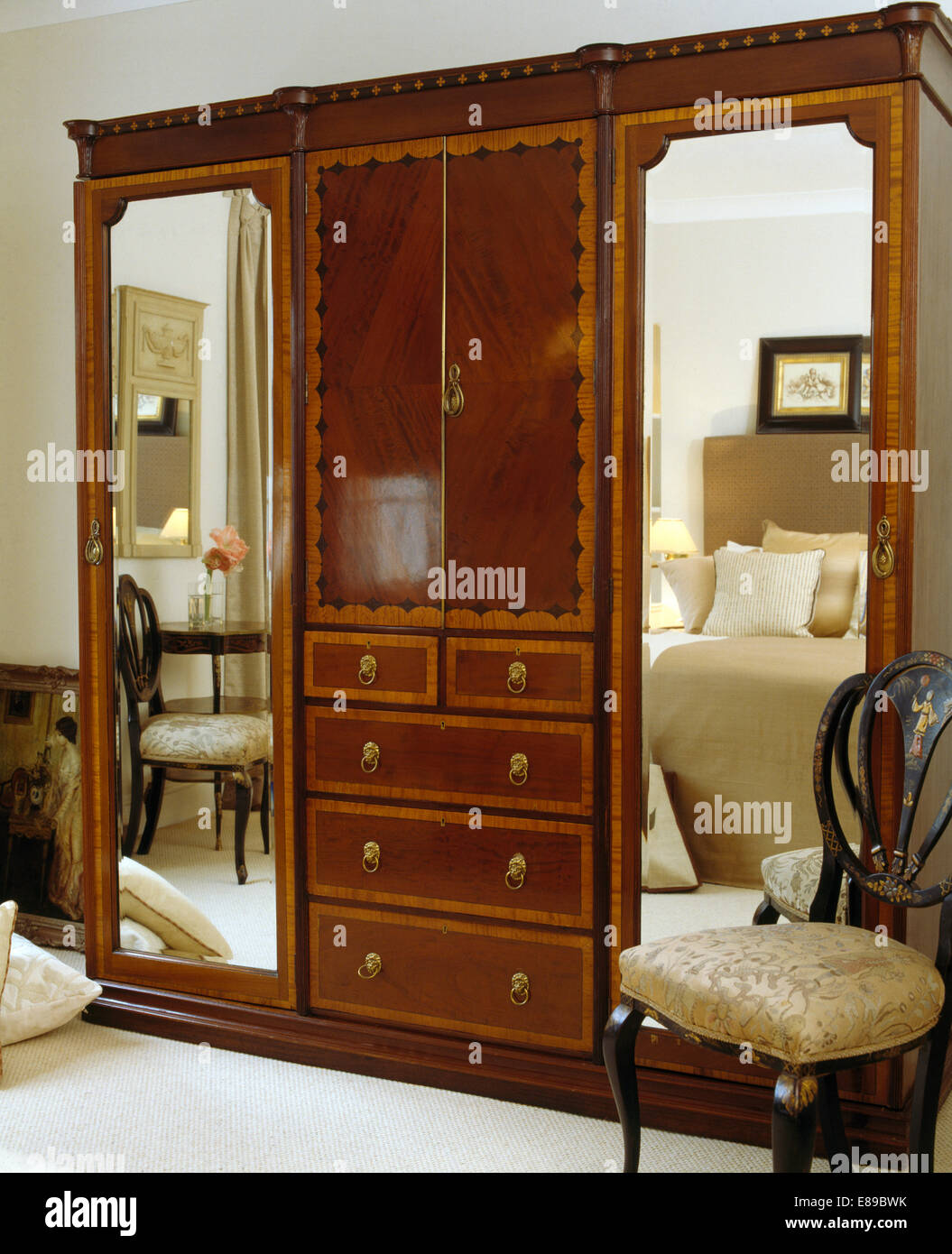 Inlaid antique chair beside large custom built inlaid wardrobe 