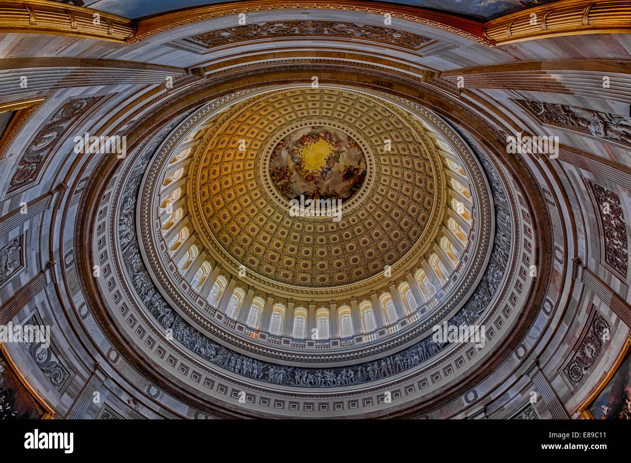 An interior view to the rotunda of the US Capitol. The rotunda is located below the Capitol dome. It's neoclassical architecture style makes the rotunda very impresive. Stock Photo