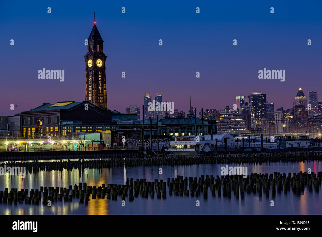 Erie Lackawanna Train Station in Hoboken, New Jersey with the New York City skyline as a backdrop during twilight. Stock Photo