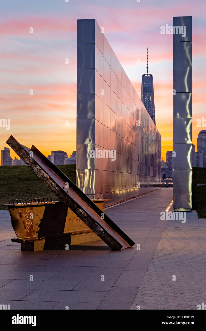 A view during sunrise to the Empty Sky Memorial at Liberty State Park in New Jersey with One World Trade Center commonly referred to as the Freedom Tower. Stock Photo