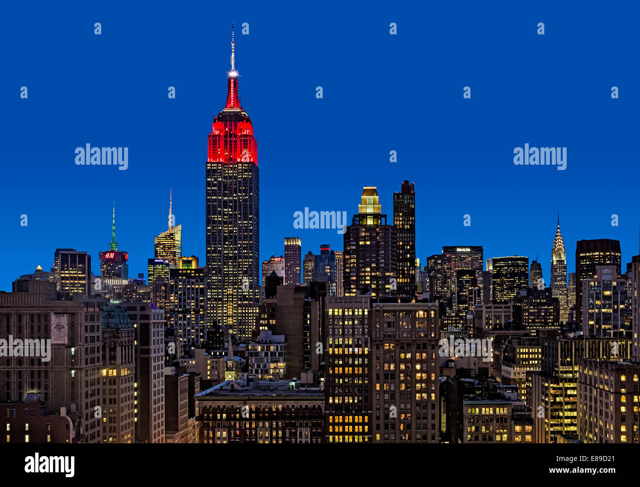 An upper view during the blue hour to the Empire State Building (ESB) along other high rises in the Flatiron District. Stock Photo
