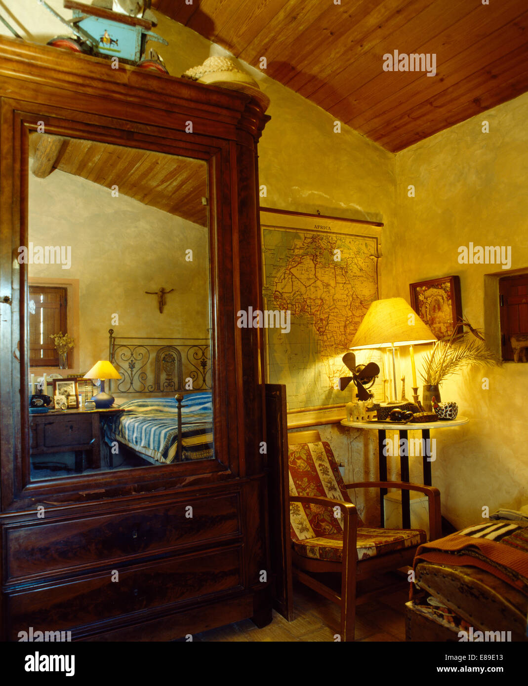 Large Old Fashioned Wardrobe With Mirrored Door In Country Bedroom