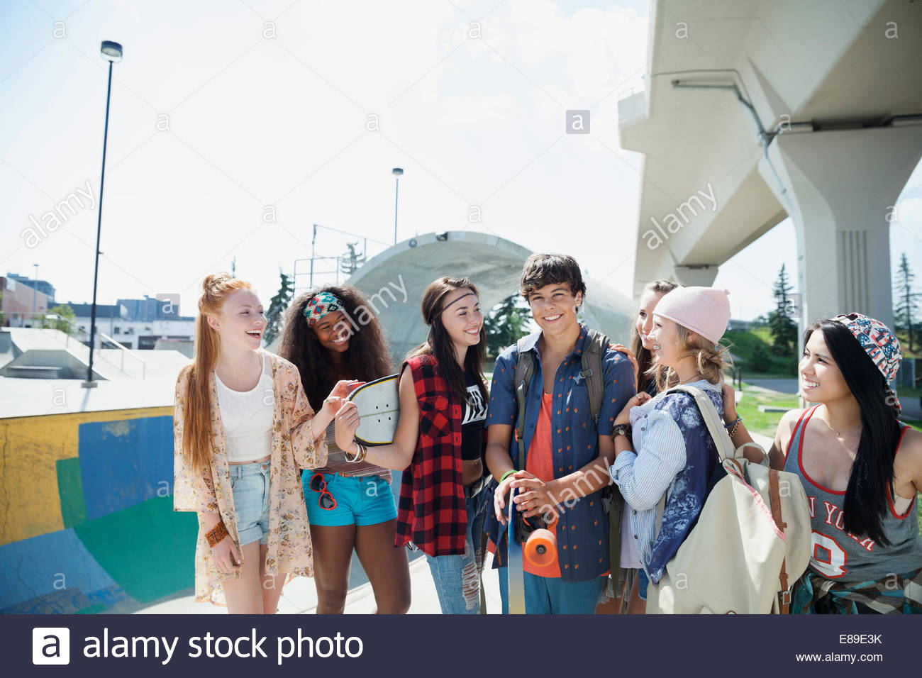 Teenagers hanging out at skateboard park Stock Photo