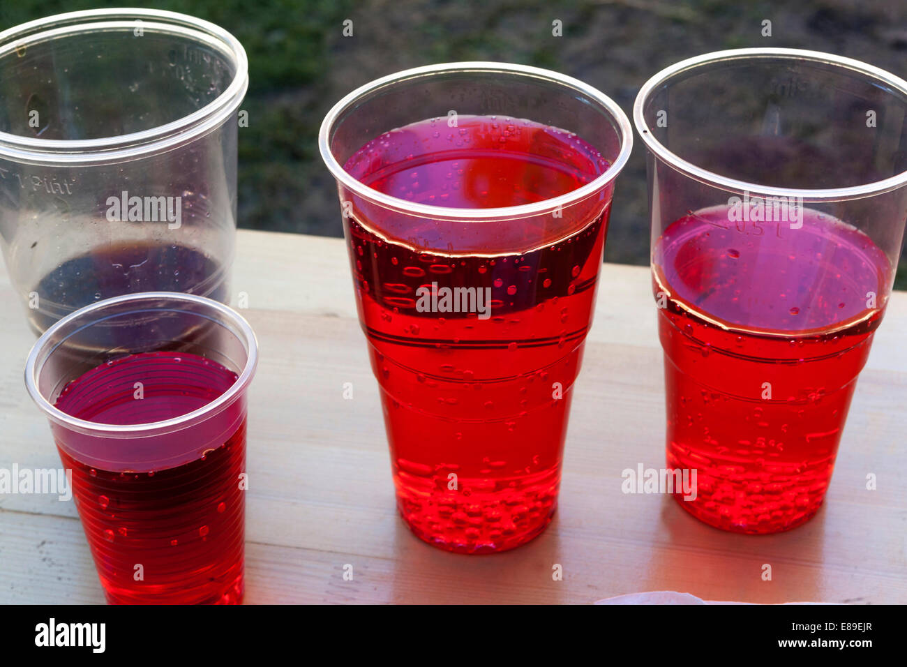 Red lemonade in plastic cups Stock Photo Alamy