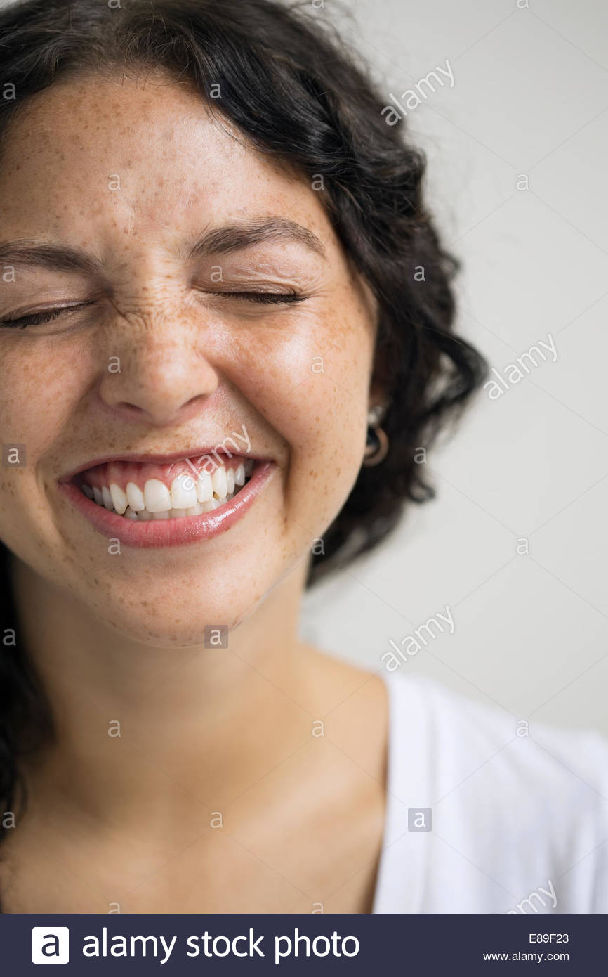 Close up of enthusiastic woman with eyes closed Stock Photo