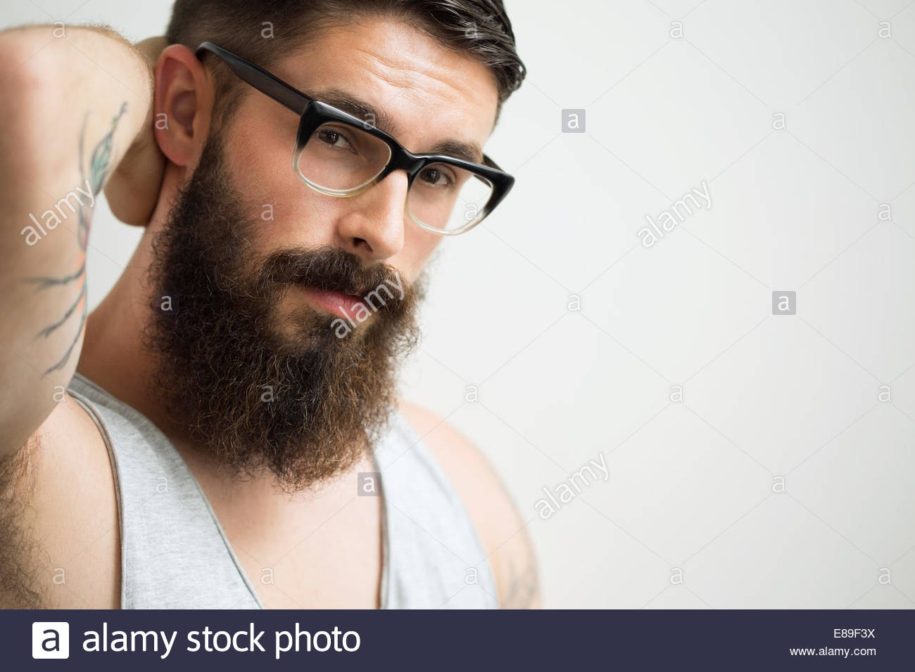 Portrait of brunette man with beard wearing eyeglasses Stock Photo