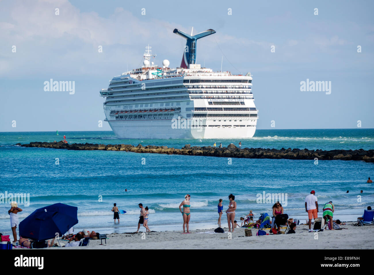 Miami Beach Florida,Atlantic Ocean,departing,cruise ship,Carnival Victory,jetty,breakwater,sunbathers,Government Cut,FL140420041 Stock Photo