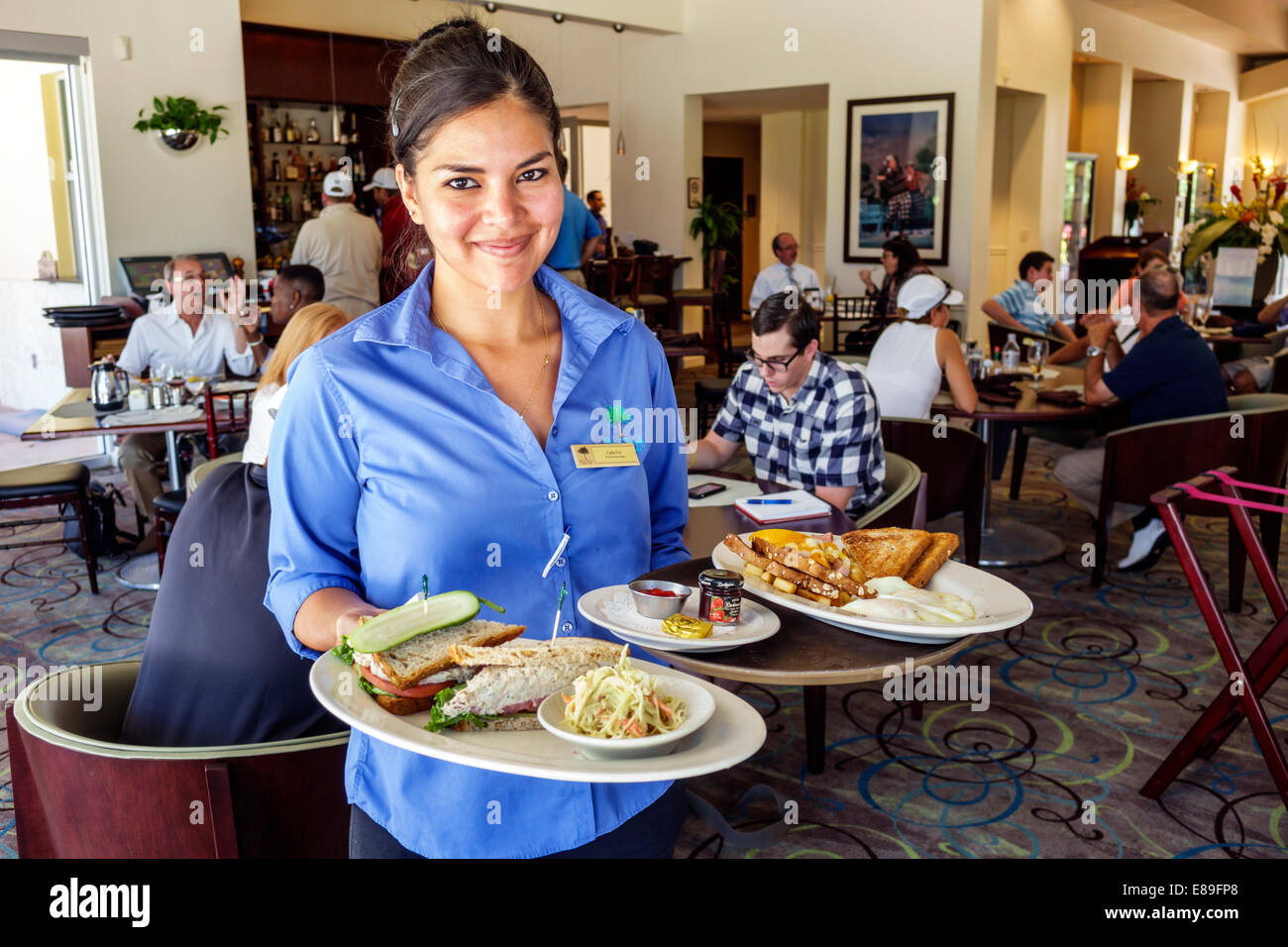 Miami Beach Florida,Golf Club,restaurant restaurants food dining cafe cafes,interior inside,Hispanic woman female women,waitress server employee worke Stock Photo