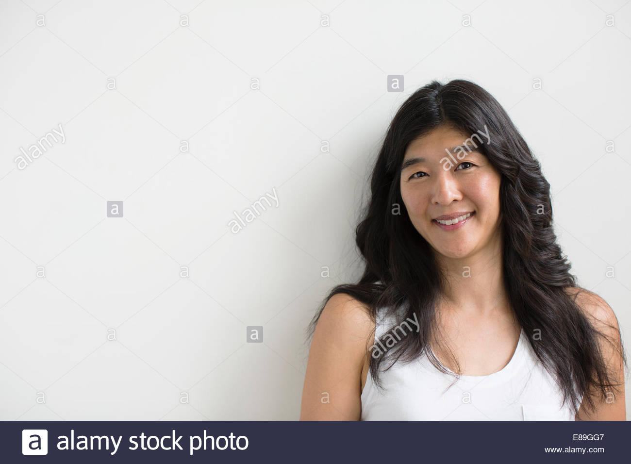 Portrait of smiling woman with black hair Stock Photo - Alamy