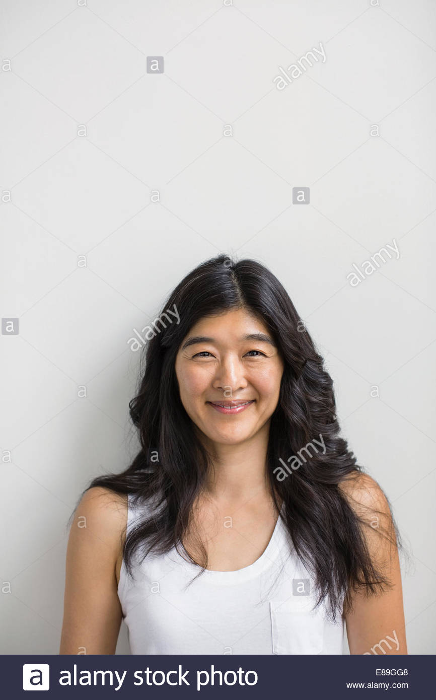 Portrait of smiling woman with black hair Stock Photo - Alamy