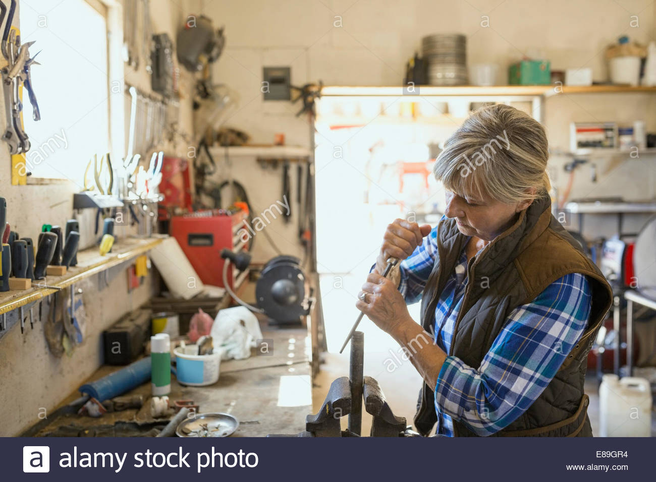 Woman sharpening tool in Stock Photo Alamy