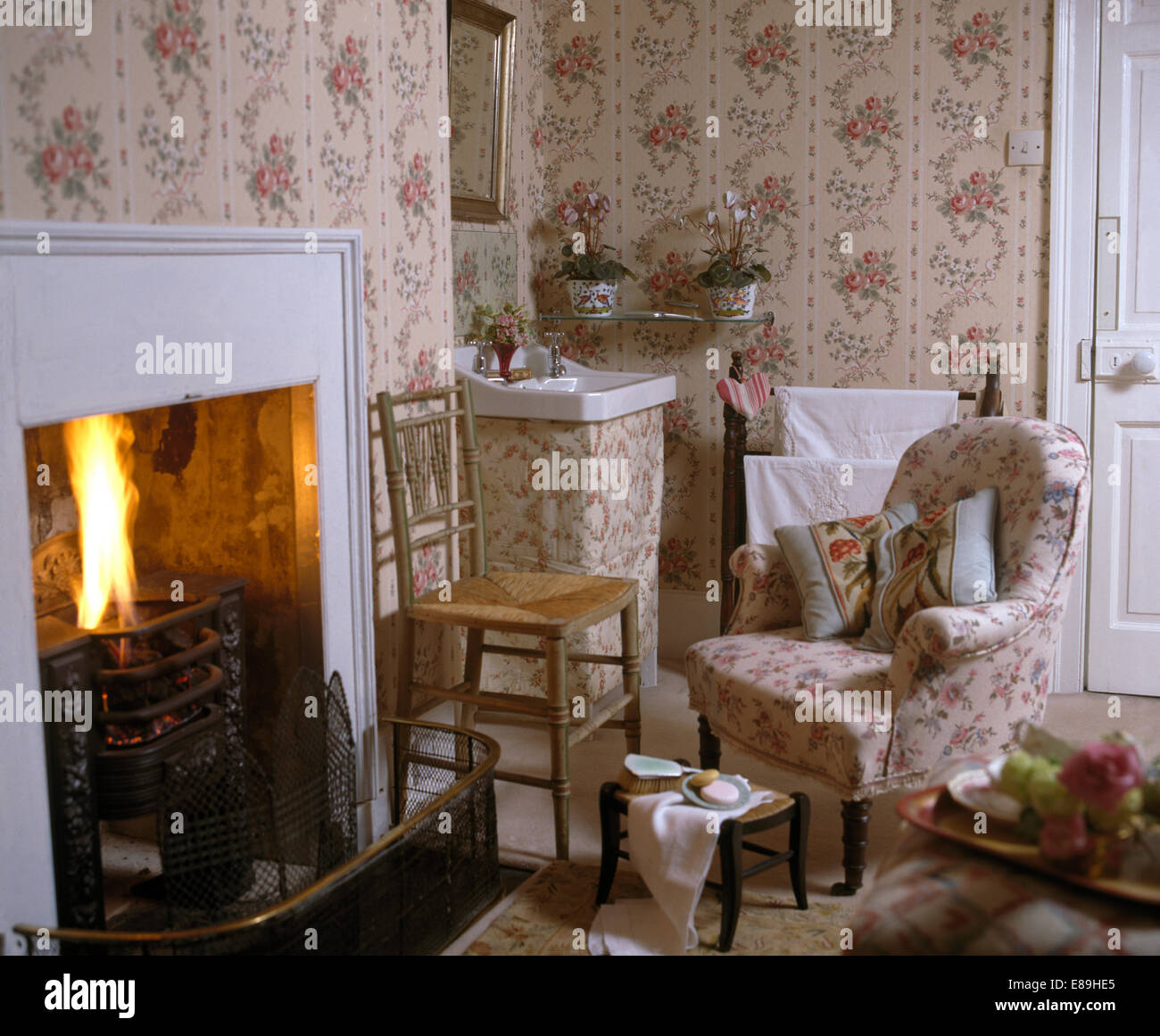 Sprigged Rose sprigged wallpaper and armchair in country bedroom with small ...