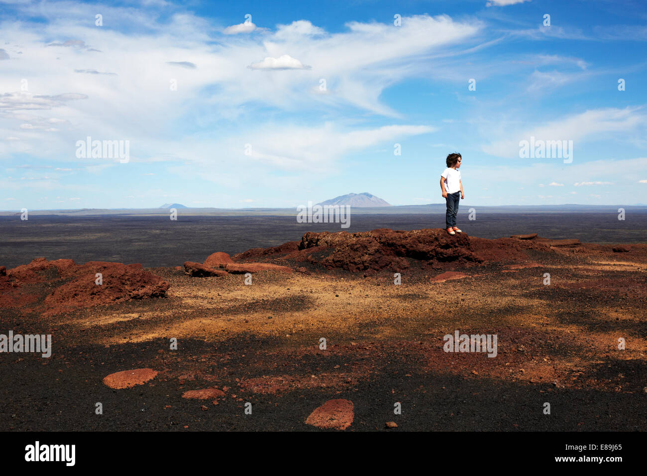 Boy Standing on rocks at Craters of The Moon Stock Photo
