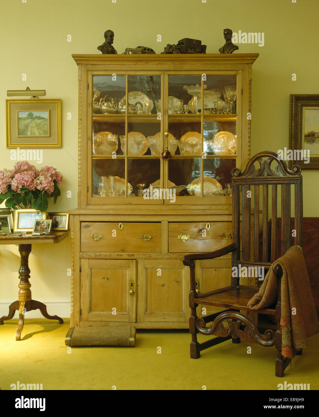 Antique Pine Dresser And Oak Chair In Country Dining Room Stock