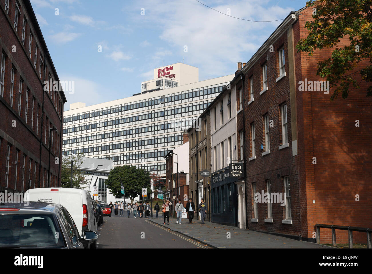 Sheffield Hallam University contrasts with old factory buildings. Sheffield city centre England UK Stock Photo