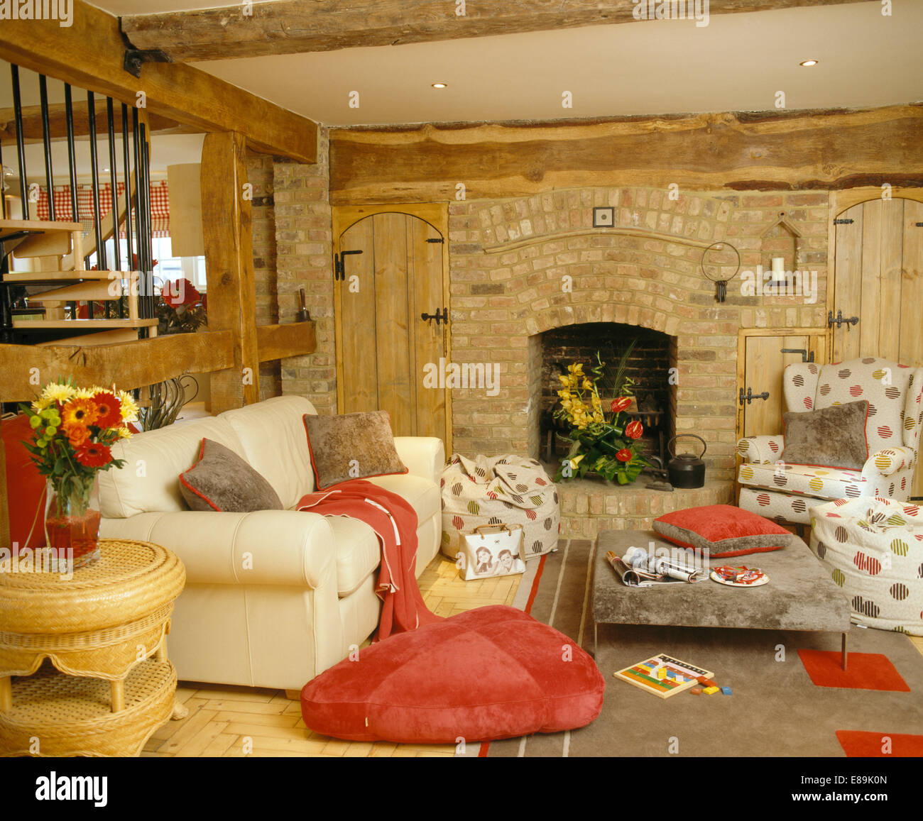 Red Floor Cushion Beside Cream Sofa In Country Living Room With