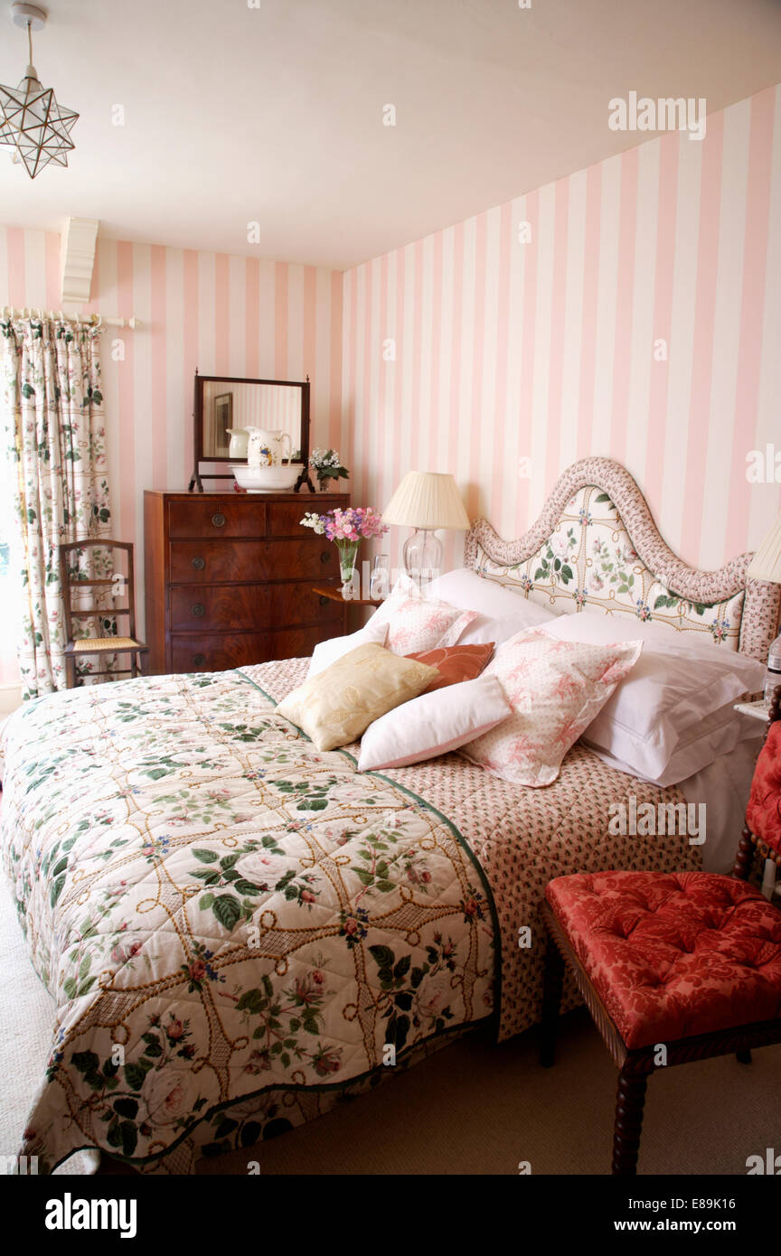 Pink Striped Wallpaper In Country Bedroom With Floral Quilt