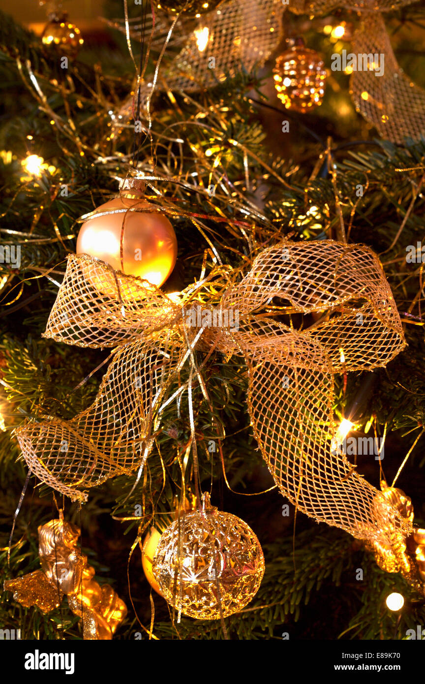 Close-up of metallic gold Christmas tree baubles and ribbon Stock Photo