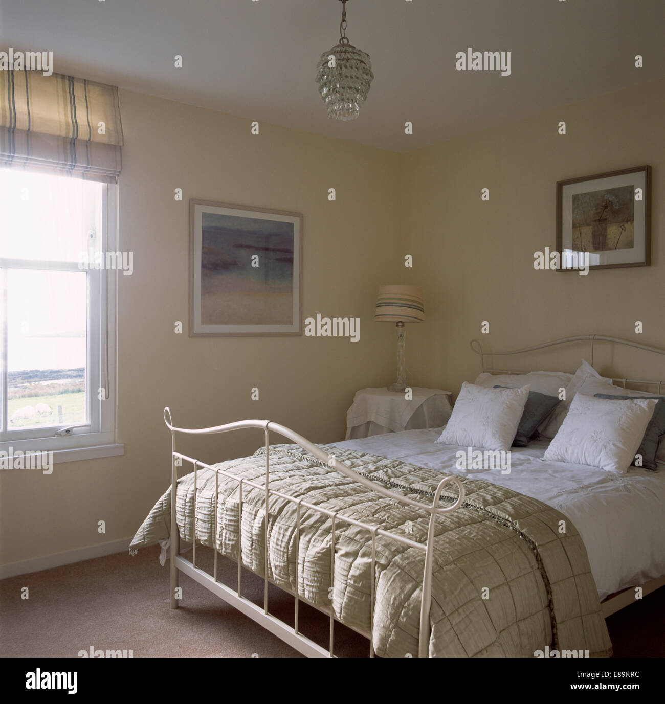 Beige Silk Quilt And White Bedlinen On Cream Metal Bed In