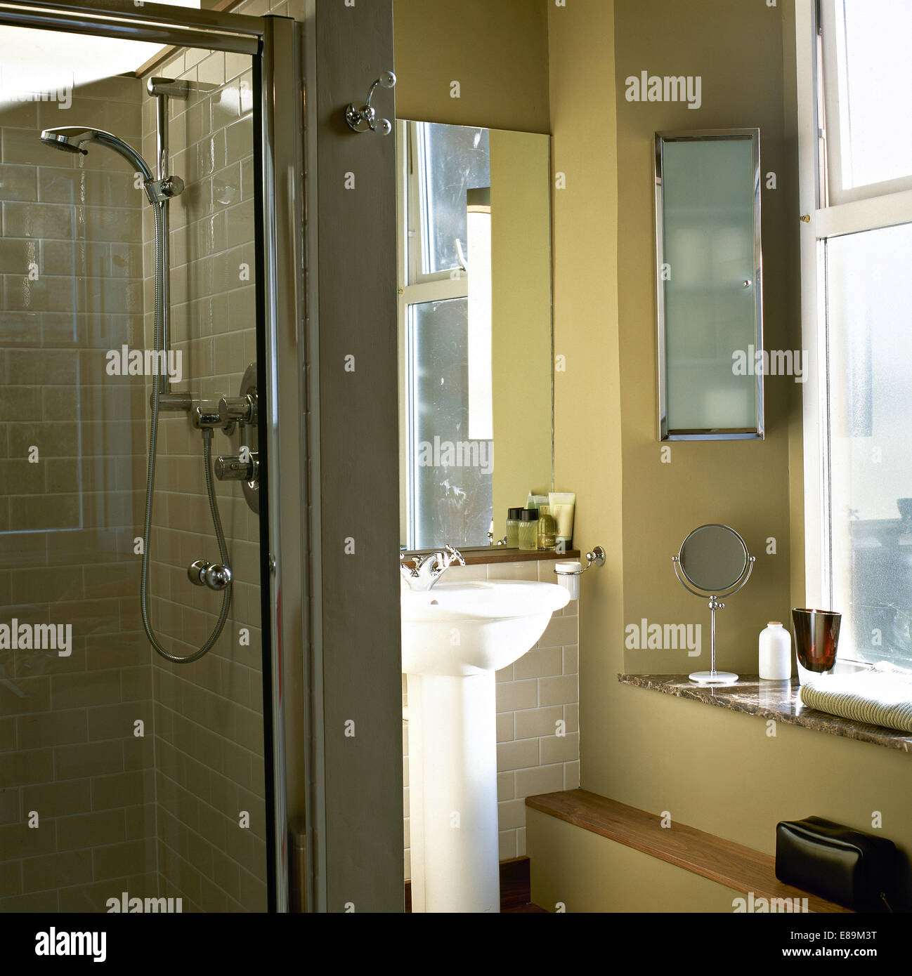 Glass shower cabinet in modern bathroom with glass front wall cabinet Stock Photo