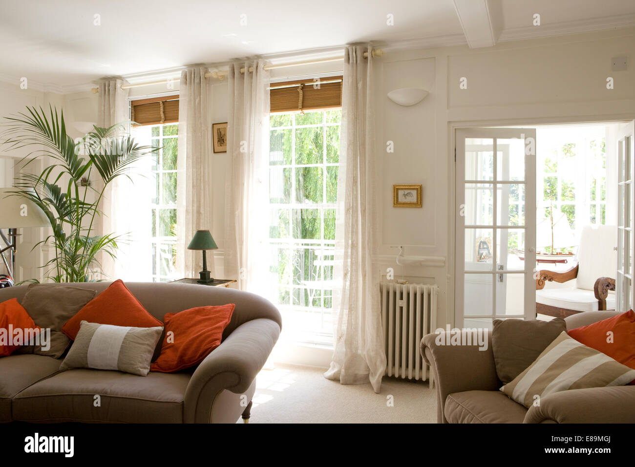 Grey Sofas With Red Cushions In White Country Living Room With