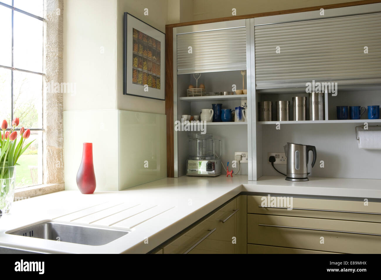 Modern Kitchen With Raised Tambour Shutters On Storage Cabinets