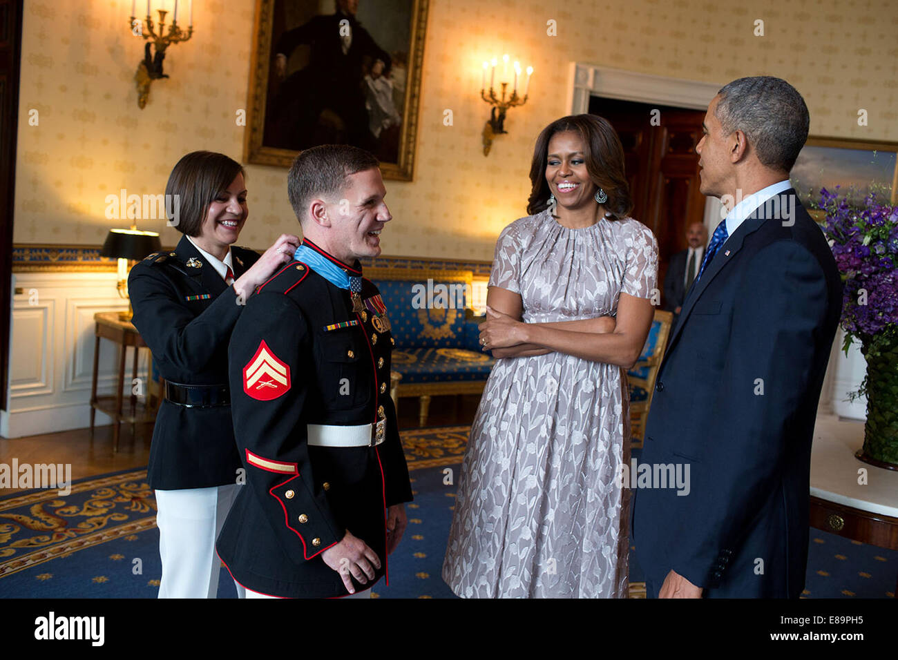 President Barack Obama and First Lady Michelle Obama talk with Corporal William 'Kyle' Carpenter, U.S. Marine Corps (Ret.) in the Blue Room following a Medal of Honor ceremony in the East Room of the White House, June 19, 2014. Cpl. Carpenter received the Stock Photo