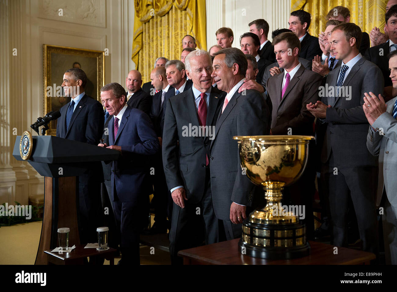 Vice President Joe Biden puts his arm around House Speaker John Boehner, R-Ohio, as PGA Tour Commissioner Tim Finchem introduces President Barack Obama during an event for the 2013 President's Cup championship teams in the East Room of the White House, Ju Stock Photo