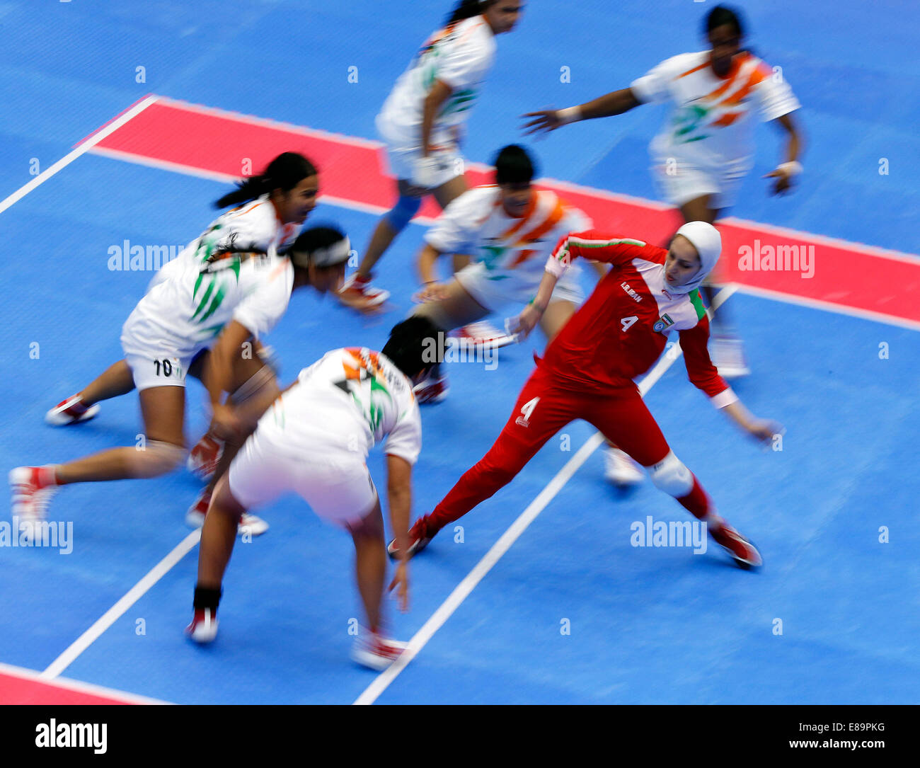 Incheon, South Korea. 3rd Oct, 2014. Miri Malihe (1st R) of Iran competes during the women's team gold medal match of kabaddi against India at the 17th Asian Games in Incheon, South Korea, Oct. 3, 2014. India defeated Iran 31-21 and claimed the title. © Shen Bohan/Xinhua/Alamy Live News Stock Photo