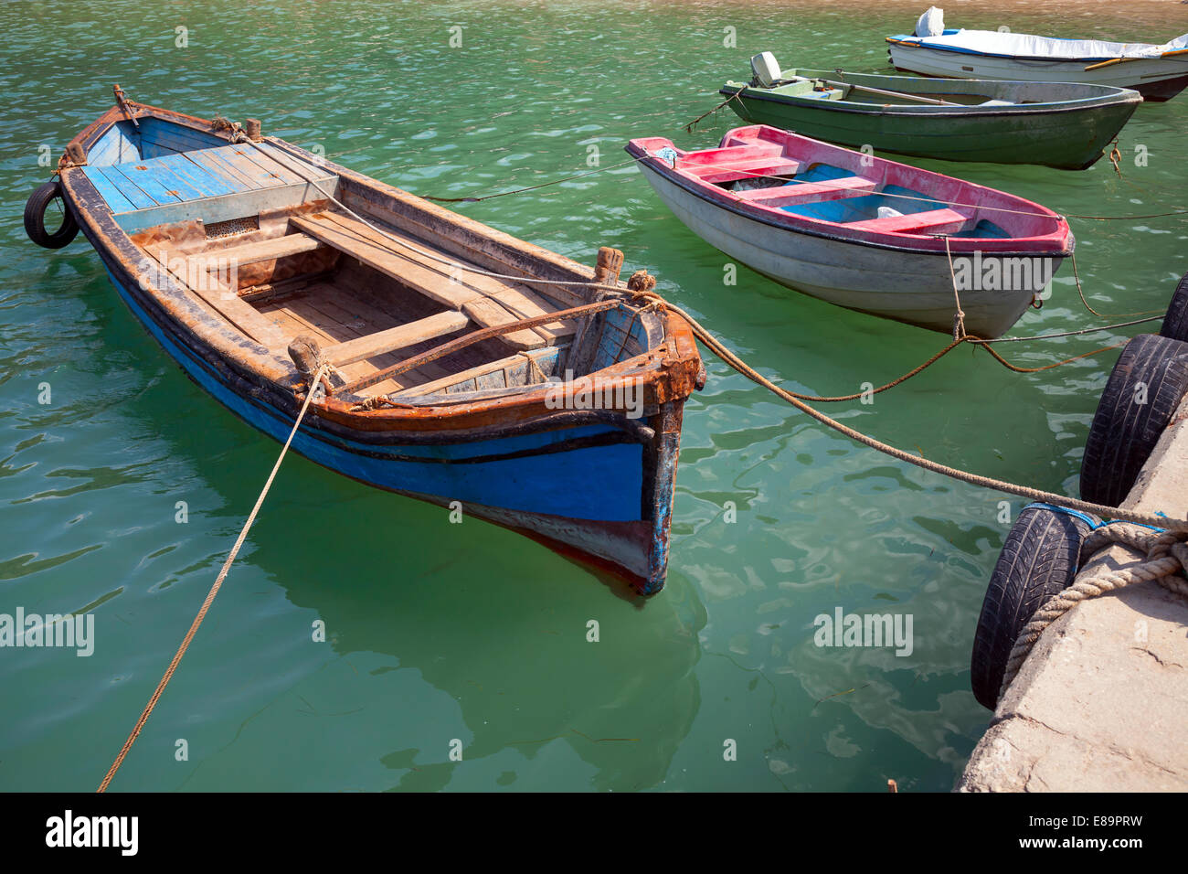 Old small wooden fishing boats moored in small Bulgarian town Stock Photo