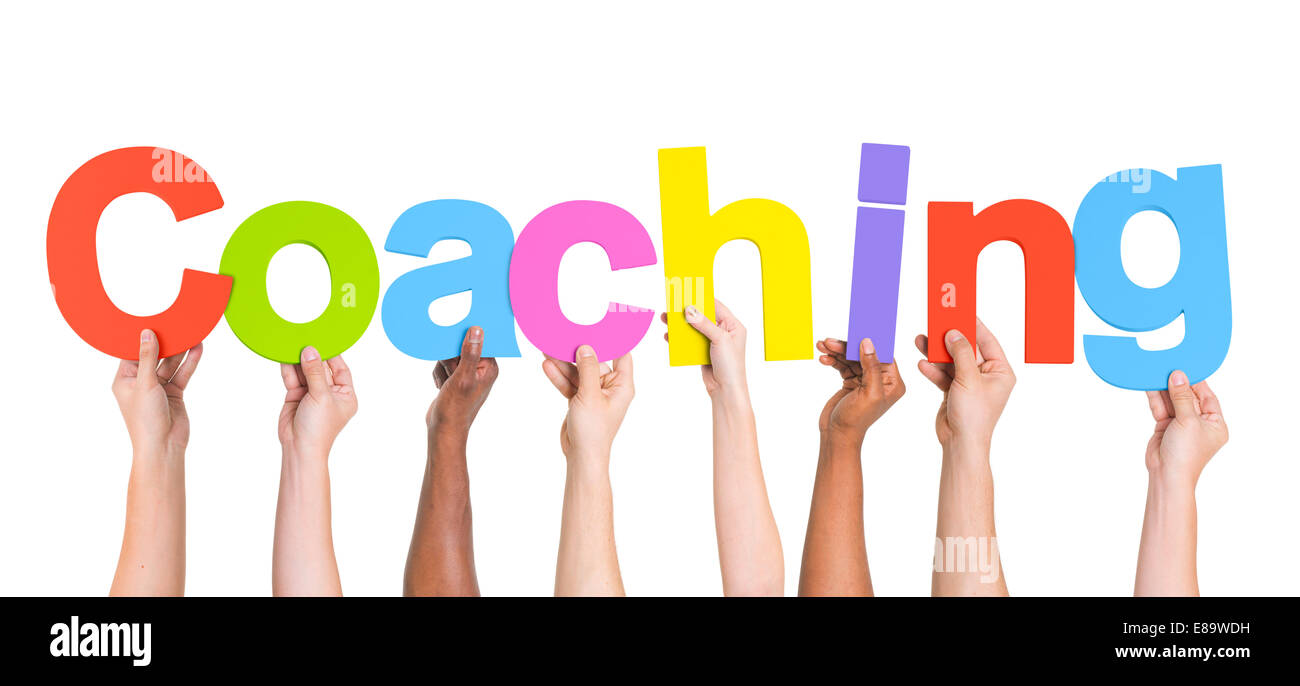 Diverse Hands Holding The Word Coaching Stock Photo