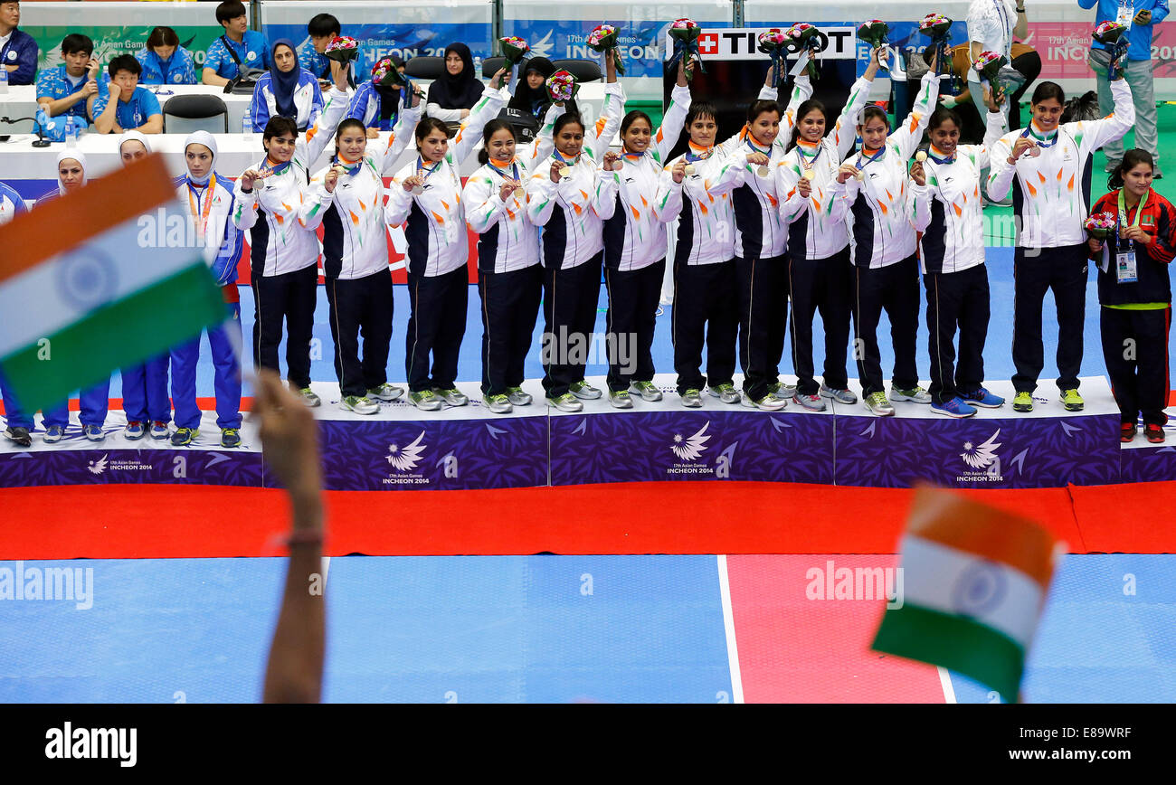 (141003) -- INCHEON, Oct. 3, 2014 (Xinhua) -- Gold medalists athletes of India pose on the podium during the awarding ceremony of the women's team match of kabaddi at the 17th Asian Games in Incheon, South Korea, Oct. 3, 2014. (Xinhua/Shen Bohan)(lz) Stock Photo