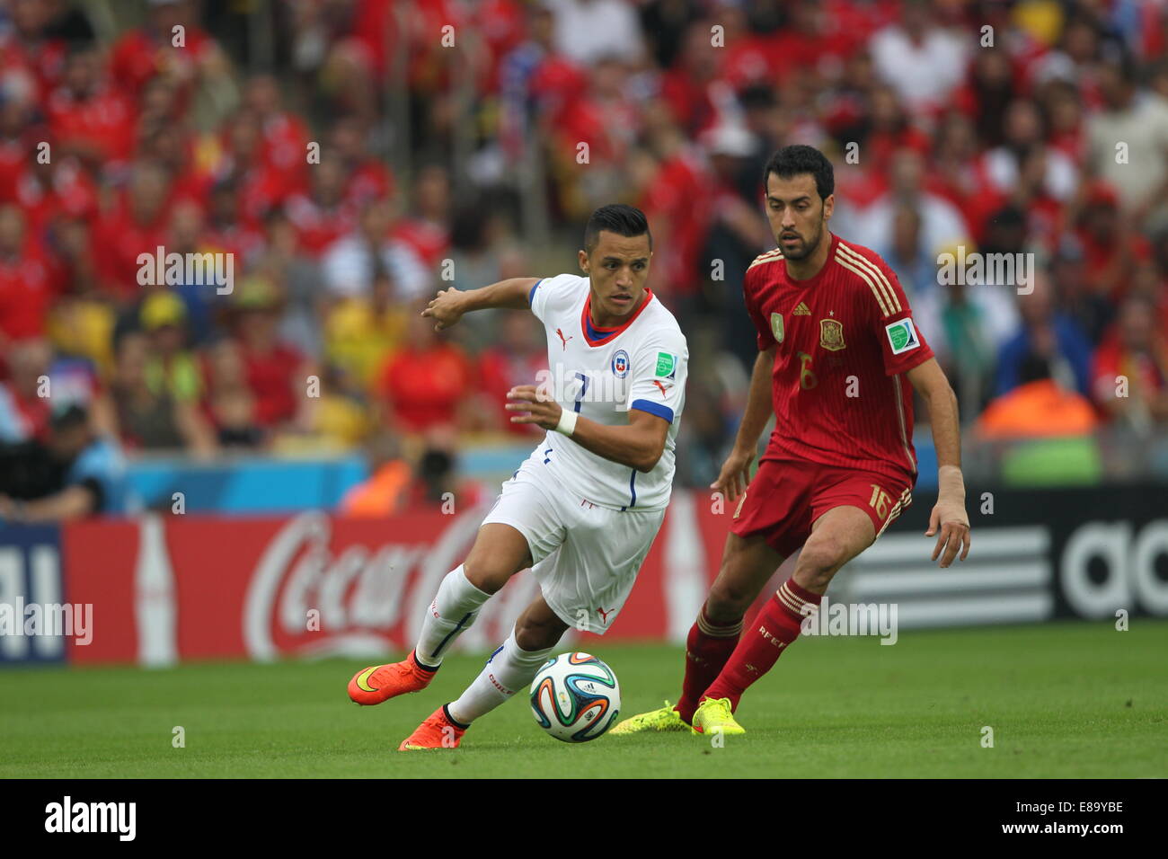 Alexis Sanchez of Chile and Sergio Busquets of Spain. Spain v Chile, group match, FIFA World Cup Brazil 2014. Maracana Stadium, Stock Photo